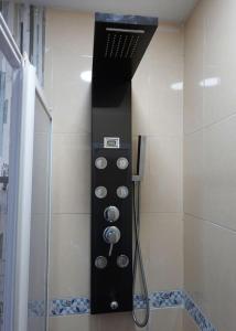 a shower with a glass door in a bathroom at En el corazón de la ciudad in Badajoz