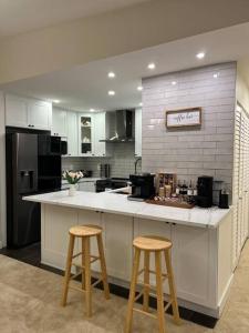 a kitchen with a counter and two bar stools at Luxury Condo-Downtown Bellevue in Bellevue