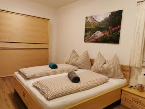 2 Betten in einem Schlafzimmer mit Wandgemälde in der Unterkunft Brücklerhof in Haus im Ennstal