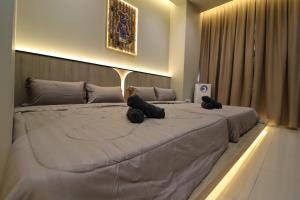 a large bed with two teddy bears sitting on it at Mykey Bali B-07-01 Melaka City in Melaka