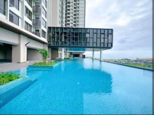 a large blue swimming pool in front of a building at Mykey Bali B-07-01 Melaka City in Melaka