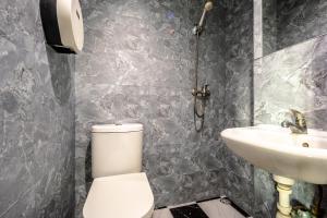 a bathroom with a toilet and a sink at K Hotel 1515 in Singapore +18 photos