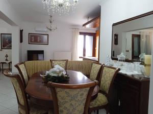 a dining room with a table and a mirror at EvgatisBeach Loyskoy 2 in Myrina