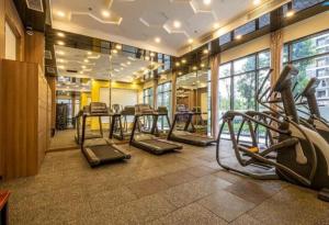 a gym with treadmills and ellipticals in a room at Apartment 1BR FL28th-Ruby-Vinhomes Ocean Park in Hanoi