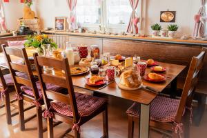 a wooden table with breakfast food on it at Bnbetschart in Muotathal