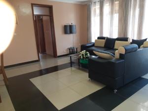 a living room with a couch and a chair at SERENITAS ApartHotel in Kigali