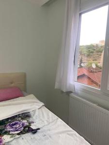 a bedroom with a bed and a window with a view at 2bedroom cozy apartment in Istanbul