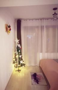 a bedroom with a christmas tree in a room at Studio Adela in Poiana Brasov