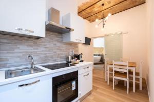 a kitchen with a sink and a stove at L'Antica Voltina in Nettuno