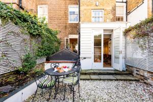 a small patio with a table and two chairs at The Notting Hill Townhouse in London