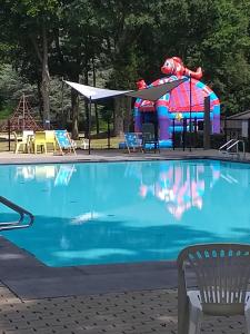 a swimming pool with a playground and a water slide at Den 1 Hengelhoef in Houthalen-Helchteren