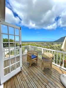 a balcony with chairs and a view of the ocean at Windrose, Noordhoek, sensationeller Meerblick in Cape Town