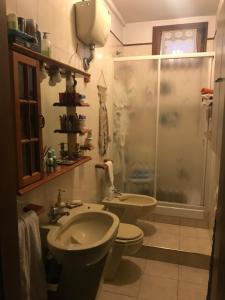 a bathroom with a sink and a toilet and a shower at Le Pergole in Trieste