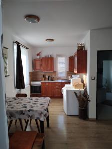 a kitchen with a table and a kitchen with wooden cabinets at Apartmán Bystré in Bystré