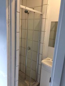a bathroom with a shower and a toilet and a sink at Elgar 67 in Burwood