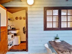 a kitchen with a wooden table and a window at בקתת מטיילים in Mitzpe Hila