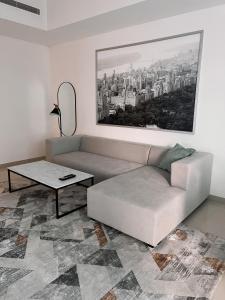 a living room with a couch and a table at Stylish 2 bdr in Dubai Marina & hotels beach access available in Dubai