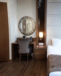 a hotel room with a desk and a mirror at Grand Hotel Downtown in Amsterdam