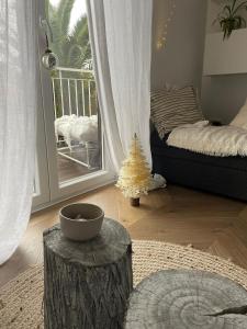 a room with a bed and a table with a tree stump at MyPalmasSuite with free parking in Opatija in Opatija