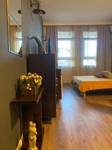 um quarto com uma cama e uma mesa com flores em Studio Nr 6 em Bansko