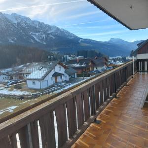 a balcony with a view of a town and mountains at Haus Mundl in Tauplitz