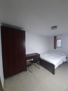 a bedroom with a large bed and a desk at Vila Dionysos Brasov in Braşov