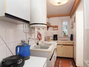 a small kitchen with a blue appliance on a counter at Serene Holiday Home in Altenfeld with Private Terrace in Altenfeld