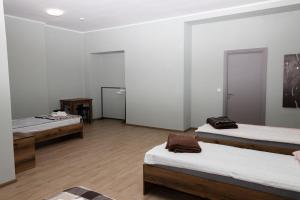 a room with three beds and a mirror at Your home in Brody