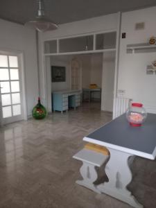 a living room with a table and a counter at Wendy House Apartament in Bari +38 photos