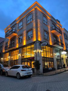 un edificio con dos coches estacionados frente a él en HANENDE HOTEL, en Estambul