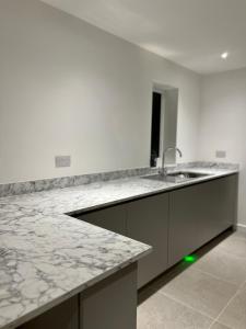 a kitchen with a sink and a counter top at Berkshire stays in Birmingham