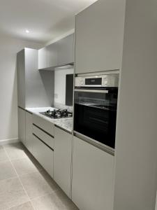 a kitchen with white cabinets and a stove at Berkshire stays in Birmingham