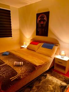 a bedroom with a bed with a picture of a head at Lux 05 in Lukavica