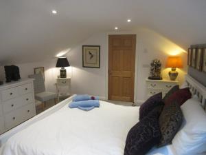 a bedroom with a white bed with a blue teddy bear on it at Straleel South in Carrick