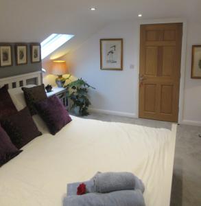 a bedroom with a large white bed with a window at Straleel South in Carrick