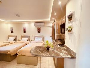 A bed or beds in a room at El mansour hotel apartmen 93