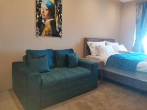 a living room with a couch and a bed at BELVEDERE A9 ( N LUX MILMARI RESORT) in Kopaonik