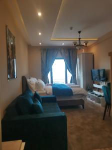 a bedroom with a couch and a bed and a window at BELVEDERE A9 ( N LUX MILMARI RESORT) in Kopaonik