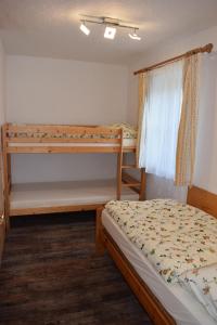 a bedroom with two bunk beds and a window at Ski apartment St. Johann in Tirol, Kitzbuheler Alpen in Sankt Johann in Tirol