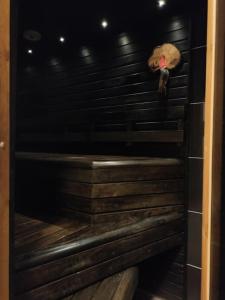 a room with a wooden staircase with a bird on the wall at Guesthouse Pekkala in Rovaniemi