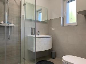 a bathroom with a shower and a sink and a toilet at Villa SeaBreeze in Kali +33 photos