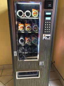 a vending machine with canned food inside of it at Scottish Inn - Nashville in Nashville +27 photos