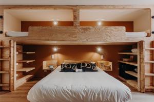 a bedroom with a bed with two bunk beds at Hôtel PALMITO in Biarritz