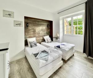 Giường trong phòng chung tại La Rose Des Vents