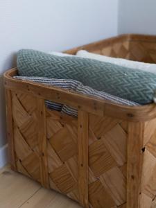 a wooden basket with a pillow on top of it at Lovely, bright apartment overlooking nature in Fiskebäckskil