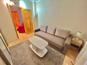 a living room with a couch and a table at JAUNA apartments in Jūrmala