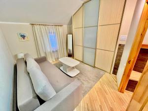 a living room with a couch and a table at JAUNA apartments in Jūrmala +18 photos