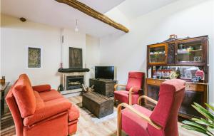a living room with two chairs and a fireplace at Nice Home In Diomondi With Outdoor Swimming Pool in Diomondi