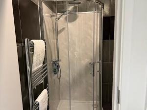a shower with a glass door in a bathroom at Luxury 1 bed apartment + 1 Sofa Bed Can sleep Up To 4 People 5 Mins Barnet Station Free Parking in Barnet