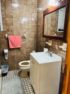 a bathroom with a toilet and a sink and a mirror at 20 Min to Manhattan New 3 Bed 1 Bath None smoked in Bronx